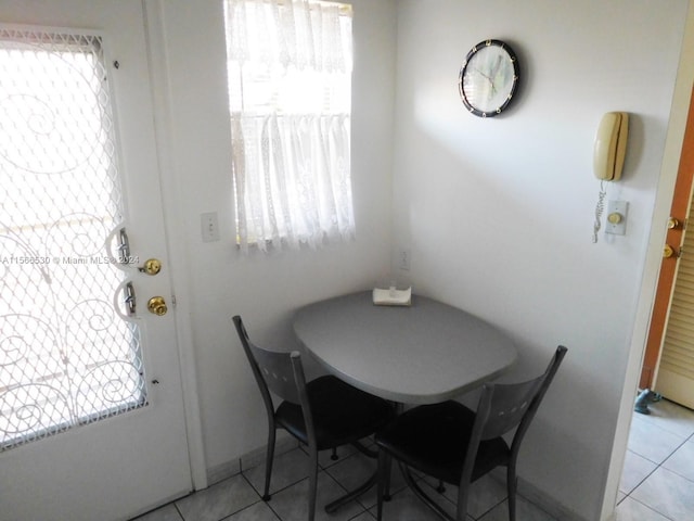 tiled dining room with a healthy amount of sunlight