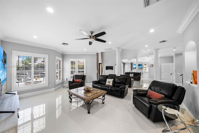 living room with decorative columns, ornamental molding, and ceiling fan