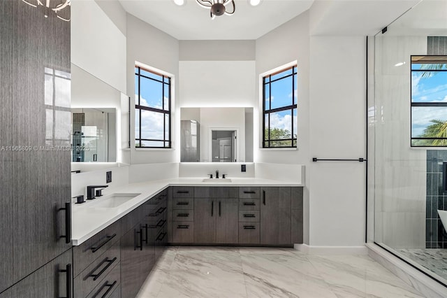 bathroom featuring walk in shower, a towering ceiling, a healthy amount of sunlight, and vanity