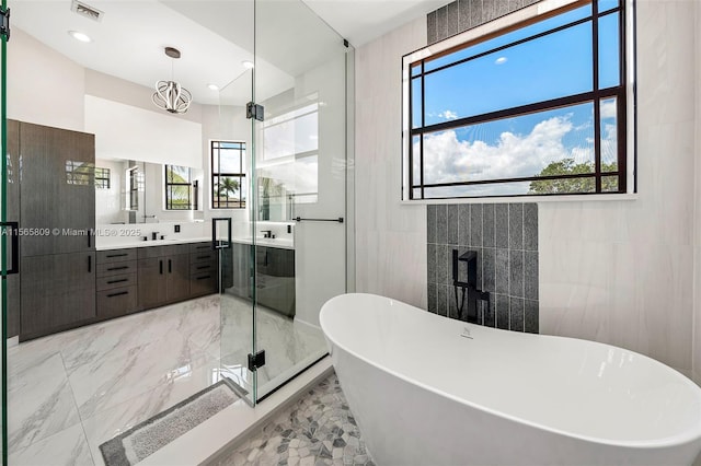 bathroom with vanity, separate shower and tub, and tile walls