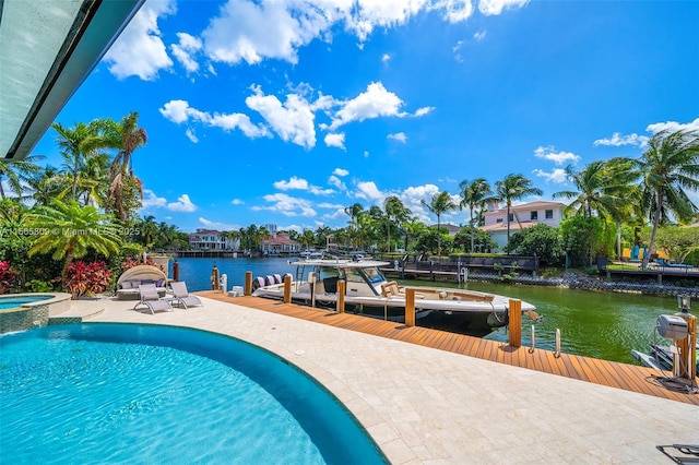 view of swimming pool with an in ground hot tub, a water view, a dock, and a patio