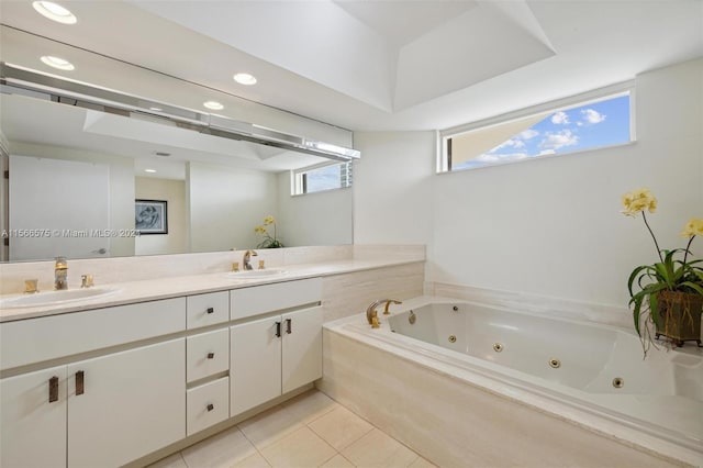 bathroom with tile patterned flooring, vanity, a healthy amount of sunlight, and a bathtub