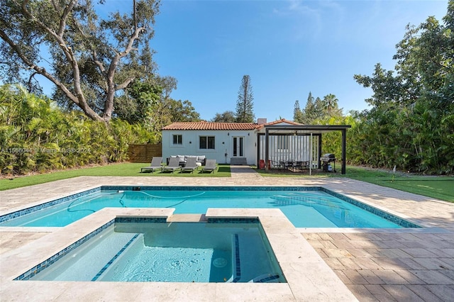 view of pool with an in ground hot tub, an outdoor living space, a yard, a gazebo, and a patio area