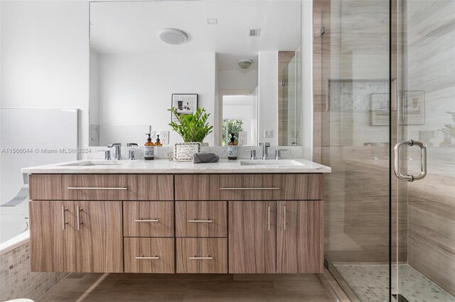 bathroom with vanity and separate shower and tub