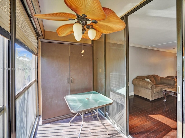 sunroom featuring ceiling fan