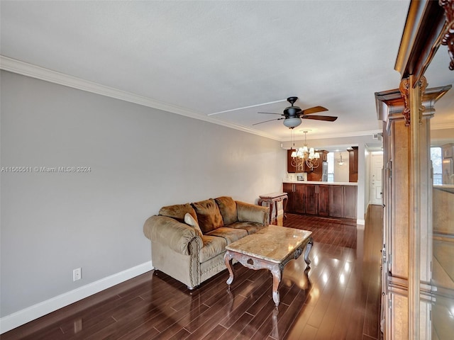 living room with ornamental molding, dark hardwood / wood-style floors, and ceiling fan with notable chandelier