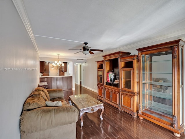 living room with dark wood-type flooring, ceiling fan with notable chandelier, and ornamental molding