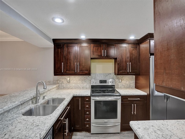 kitchen with sink, dark brown cabinets, stainless steel range with electric stovetop, light hardwood / wood-style floors, and light stone countertops