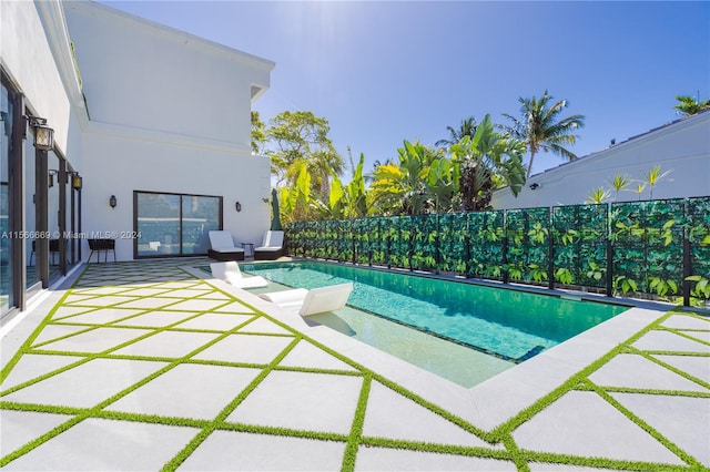 view of swimming pool featuring a patio