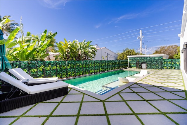 view of swimming pool with a patio area