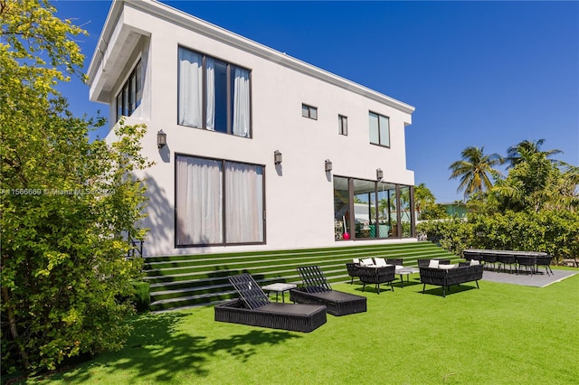 rear view of property with an outdoor living space and a lawn