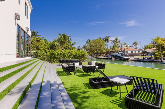 view of yard with a dock and a water view