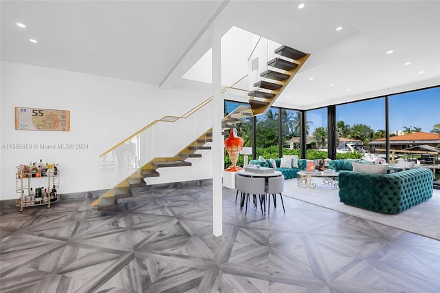 interior space featuring a wall of windows and parquet floors