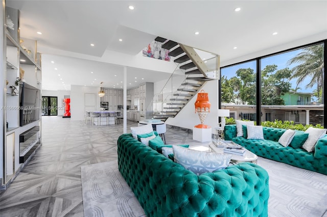 living room with light parquet floors and a high ceiling