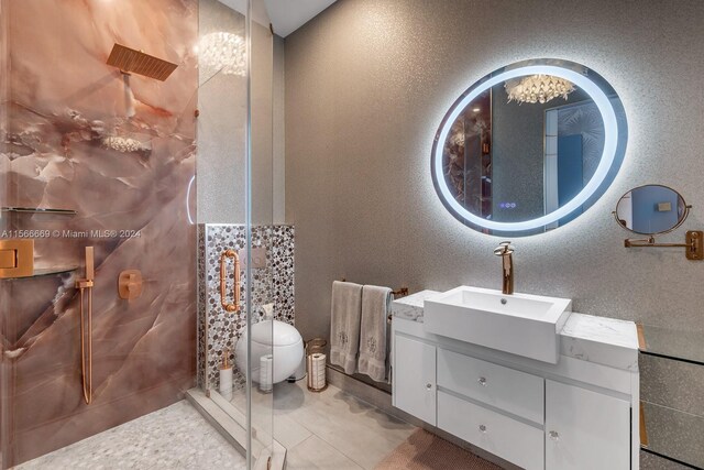 bathroom with tile floors, vanity, and toilet