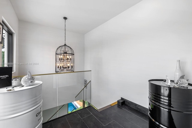 interior space featuring a notable chandelier and tile floors