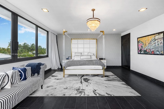 bedroom featuring dark hardwood / wood-style flooring and a chandelier