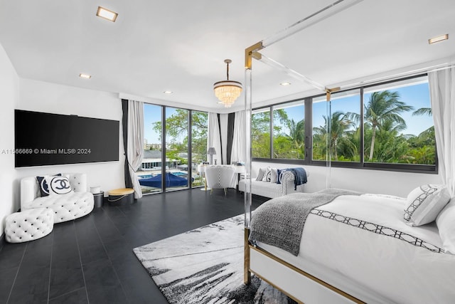 bedroom with dark wood-type flooring, an inviting chandelier, and access to outside