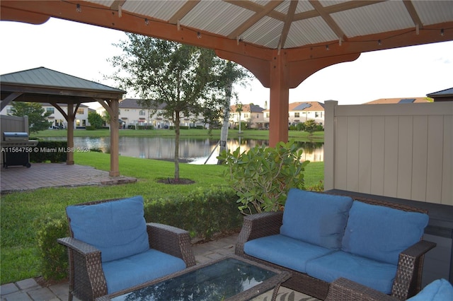 view of terrace with a water view, outdoor lounge area, and a gazebo