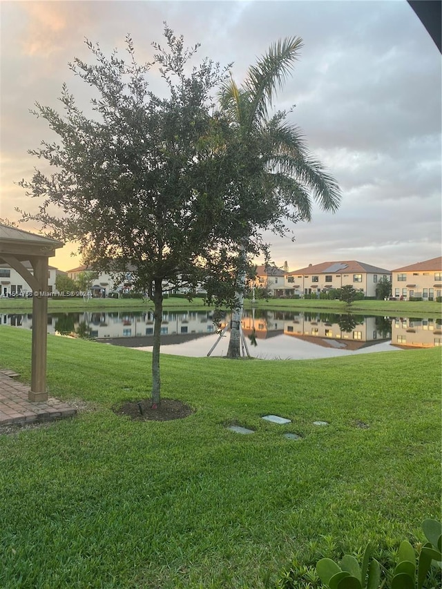 view of nearby features featuring a water view and a yard