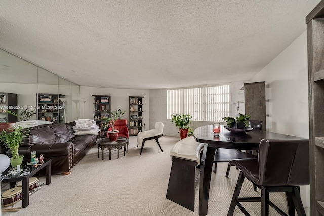 dining area featuring a textured ceiling and light carpet