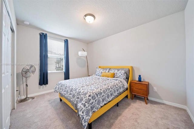 carpeted bedroom featuring a textured ceiling