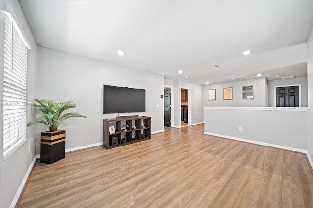 112 Towns, Haines City, FL 33844 - unfurnished living room with recessed lighting, light wood-type flooring, and baseboards