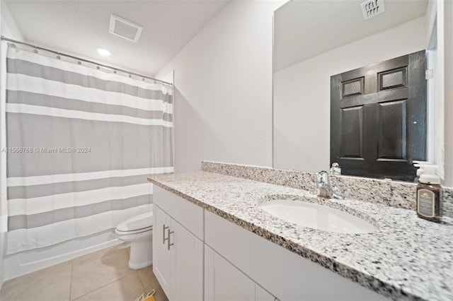 full bathroom with shower / tub combo with curtain, tile patterned flooring, vanity, and toilet