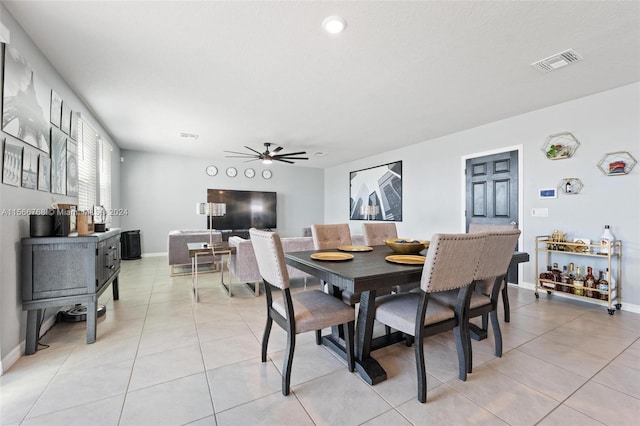 dining space featuring ceiling fan and light tile patterned floors