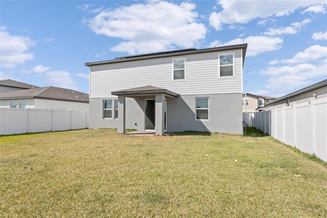 112 Towns, Haines City, FL 33844 - rear view of property with a lawn, a fenced backyard, and stucco siding