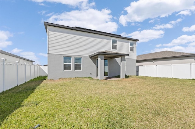 112 Towns, Haines City, FL 33844 - rear view of property with a lawn, a fenced backyard, and stucco siding