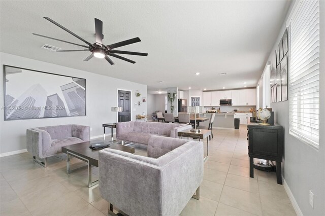 112 Towns, Haines City, FL 33844 - living room with a ceiling fan, baseboards, light tile patterned flooring, and visible vents