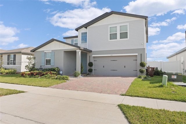 view of front of property with a garage and a front lawn