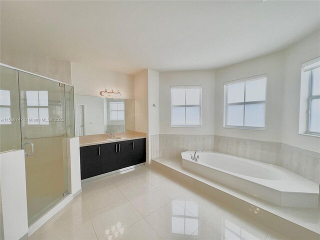 bathroom with tile patterned flooring, vanity, and a bathtub