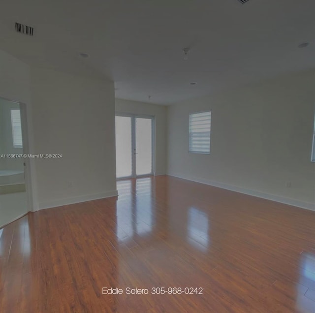 spare room featuring wood-type flooring