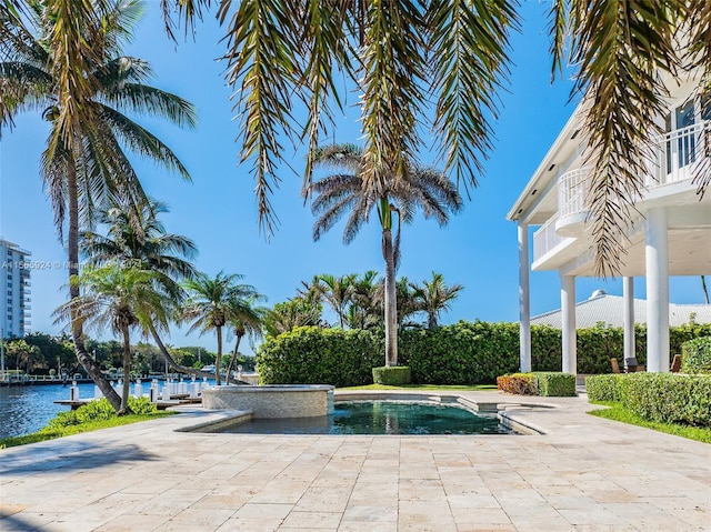 view of swimming pool with a water view