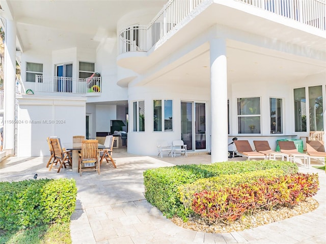 back of property featuring an outdoor living space and a patio area