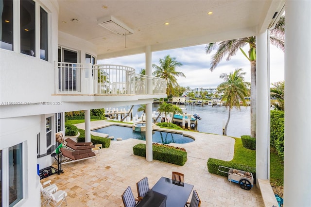 view of swimming pool featuring a water view and a patio area