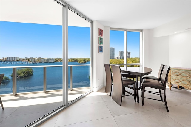 interior space featuring a water view and a wall of windows