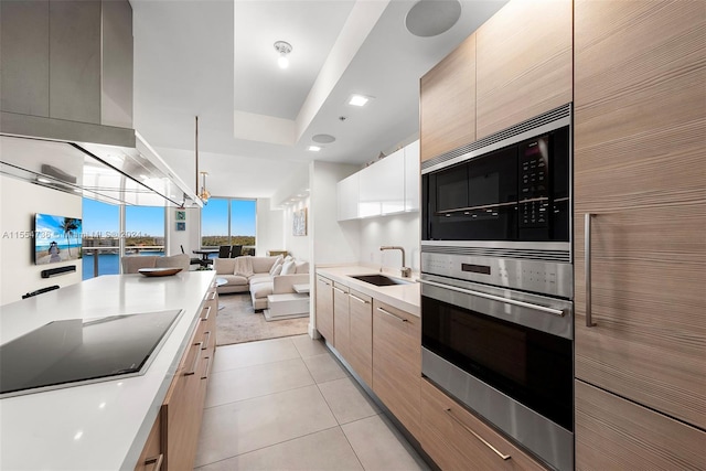 kitchen featuring light tile floors, sink, stainless steel oven, black electric cooktop, and built in microwave