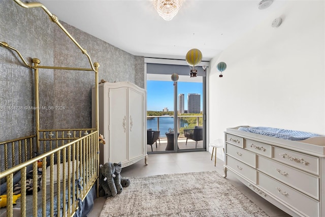 bedroom featuring light tile floors and a water view