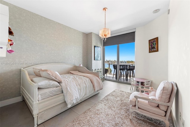 bedroom featuring light tile floors, a notable chandelier, a water view, and access to outside