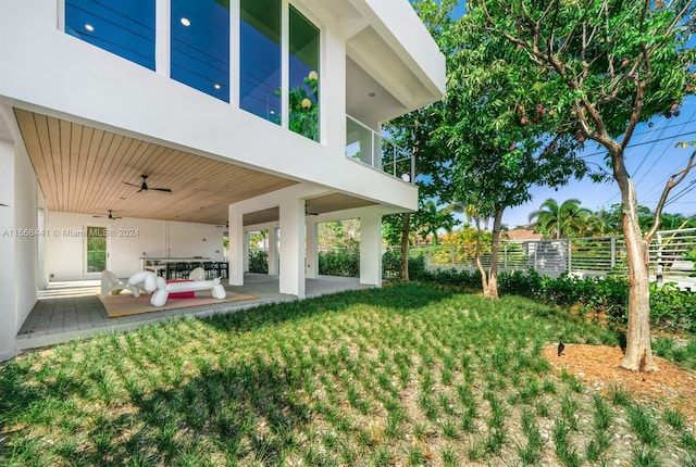 view of yard with a patio and a balcony