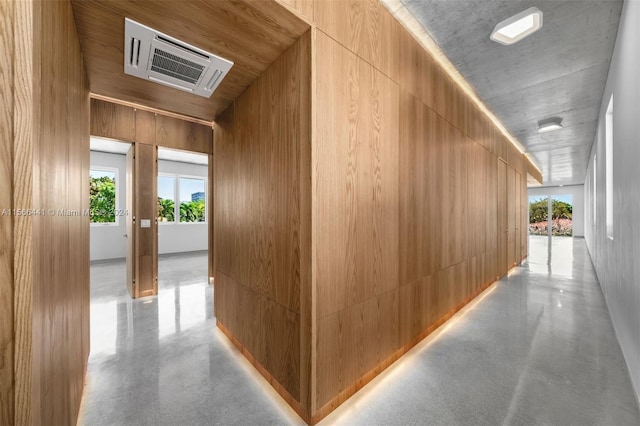 hallway featuring wooden walls