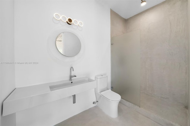 bathroom with a shower, concrete floors, and toilet