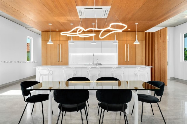 kitchen featuring pendant lighting, white cabinets, and a wealth of natural light