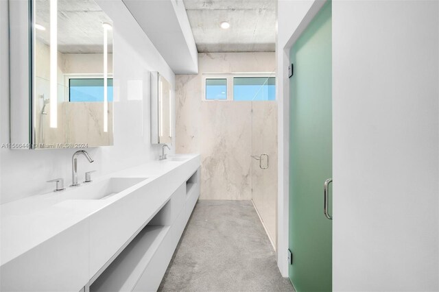 bathroom featuring vanity and a shower with door