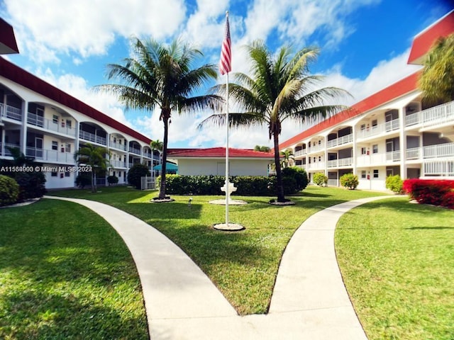 view of property's community with a lawn