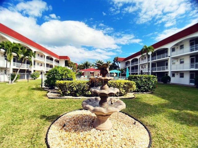 view of property's community with a lawn