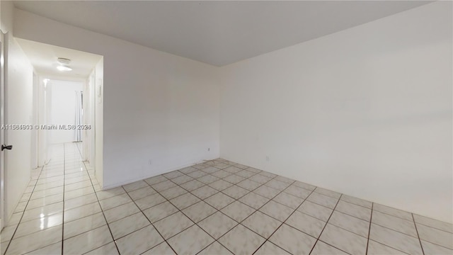 spare room featuring light tile floors